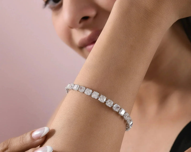 Spectrum Jewels natural diamond tennis bracelet with cushion-cut diamonds elegantly showcased on a model's wrist.