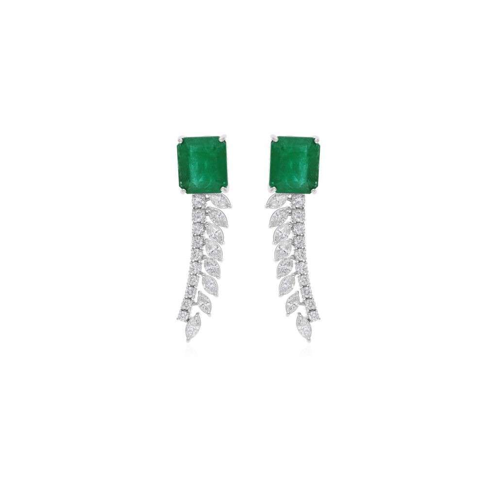 Pair of emerald green earrings with diamond-like stones on a white background